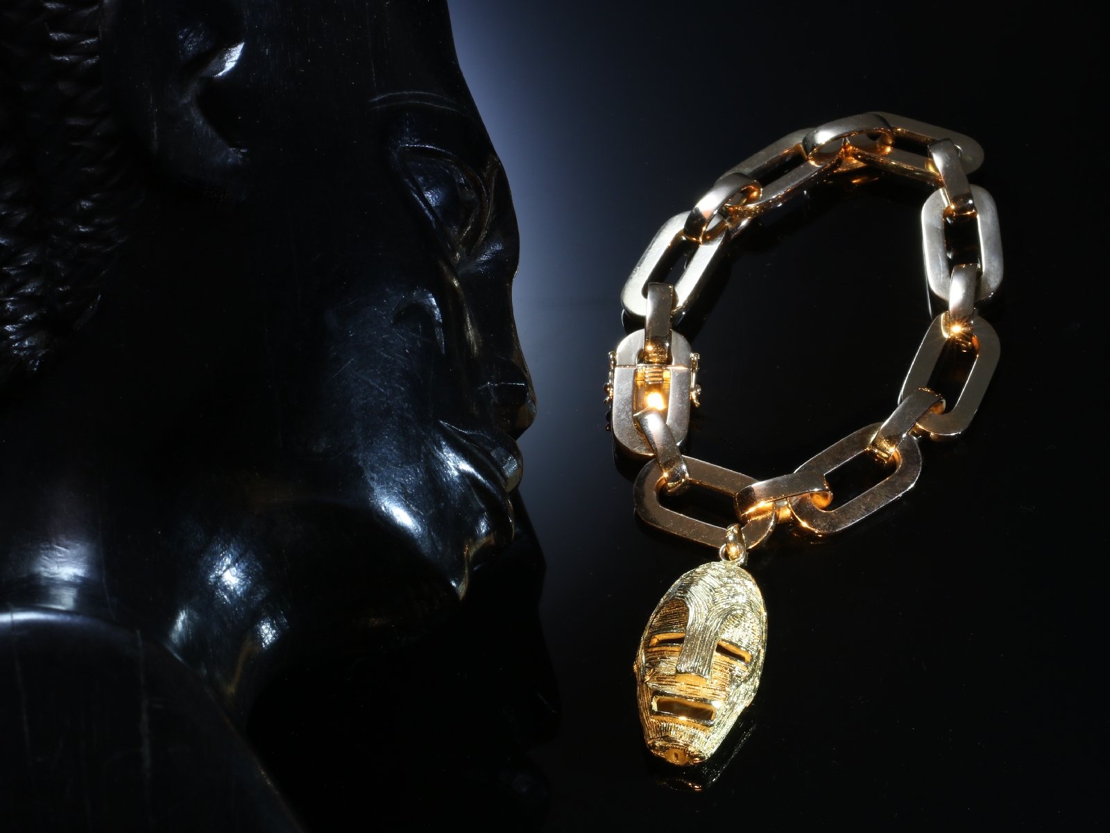 Click the picture to get to see this Vintage Fifties solid pink gold heavy bracelet with yellow gold ethnic african mask.